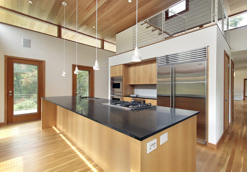 Kitchen with long rectangular island and black counter