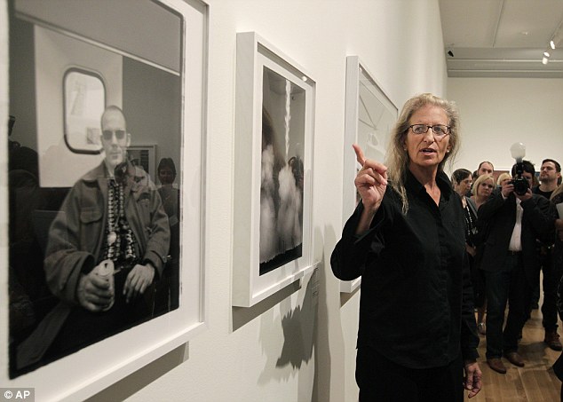 Gems: Leibovitz points to one photo while to the left of that one a black and white photograph of Hunter S Thompson sitting is seen